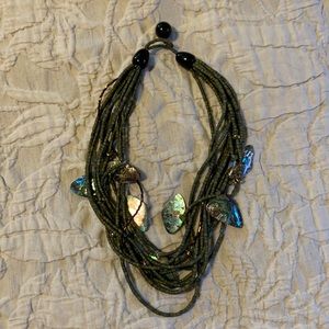 Olive green bead necklace with metal shells.